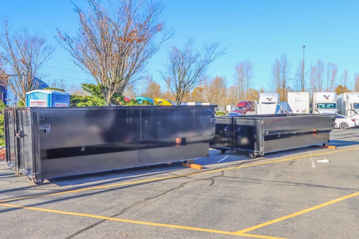 Professional dumpster rental service with roll-off container on residential driveway in Jacksonville Beach